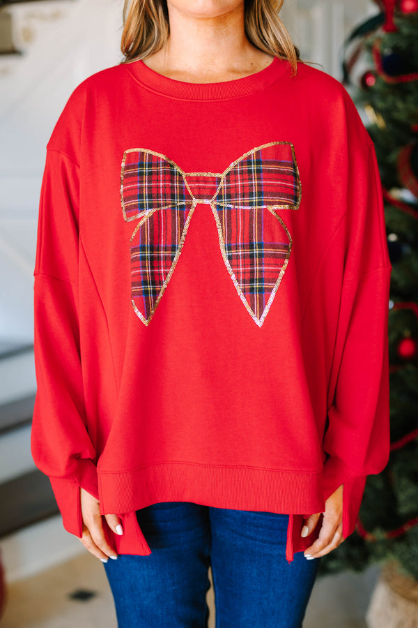 Plus Size red pullover sweatshirt with a large plaid bow graphic outlined in gold sequins.
