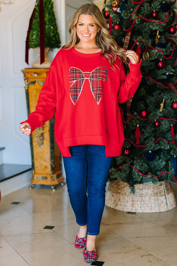 Plus Size red pullover sweatshirt with a large plaid bow graphic outlined in gold sequins.