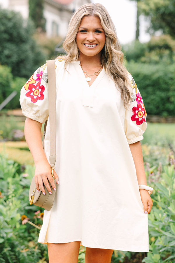 Plus Size cream cotton dress with a V-neckline and puff sleeves featuring colorful floral embroidery.
