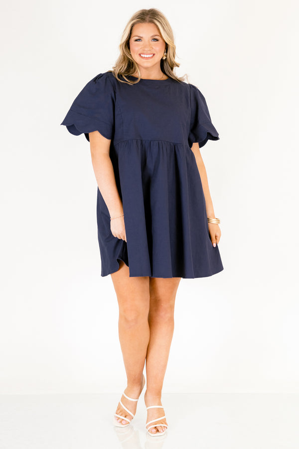 Chic Soul plus size clothing, navy flowy knee length dress with short bell sleeves that have a scalloped look at the end of the sleeves