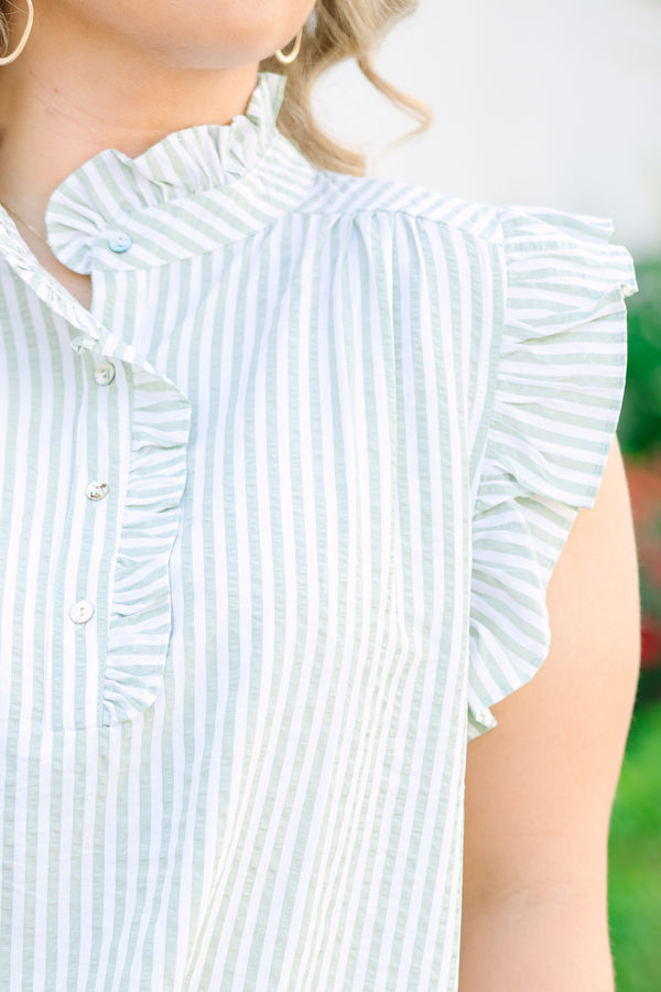Light green and white pin stripe ruffle cap sleeve top with 3 button neckline and ruffle detailing on the neckline