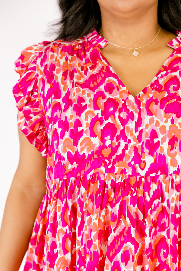   Chic Soul plus size clothing, pink top with flutter sleeves a v-neckline and a pink and orange abstract pattern 