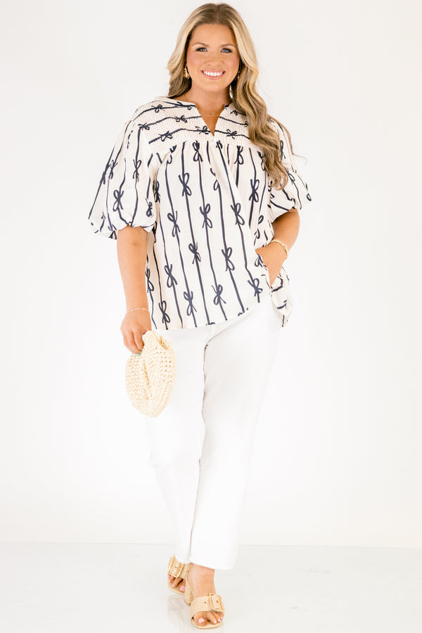 Chic Soul plus size clothing, off white short sleeve top with vertical navy blue lines and bows on the top and horizontal navy blue lines and bows along the top with a v-neckline