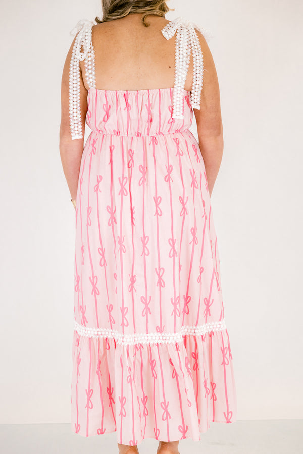 Chic Soul plus size clothing, light pink tiered maxi dress with dark pink bow pattern and white lacy ribbon trim and tie straps