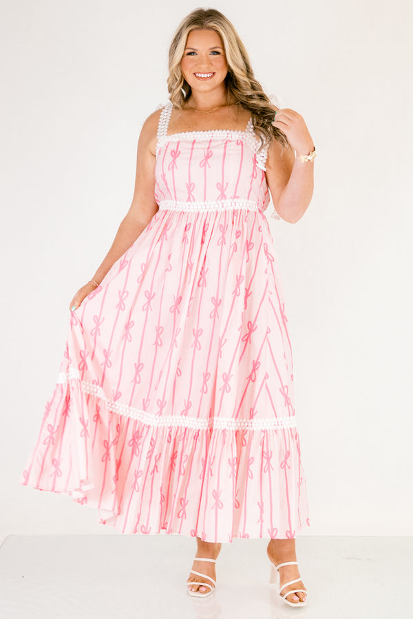 Chic Soul plus size clothing, light pink tiered maxi dress with dark pink bow pattern and white lacy ribbon trim and tie straps