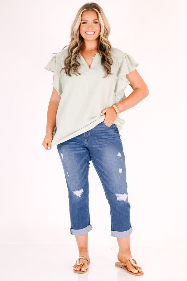 Chic Soul plus size clothing, medium wash distressed denim capris with a cuffed hem.