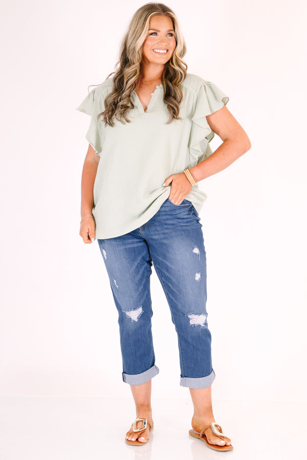 Chic Soul plus size clothing, medium wash distressed denim capris with cuffed hems.