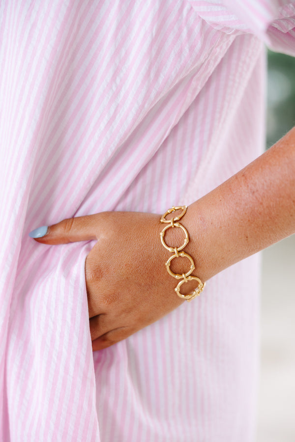 Gold link bracelet featuring a textured bamboo-inspired circular design.