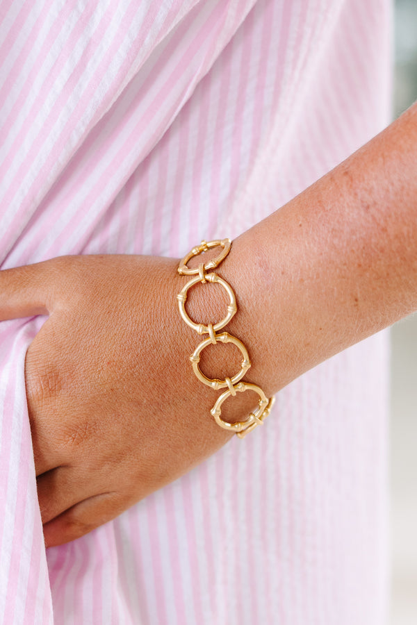 Gold link bracelet featuring a textured bamboo-inspired circular design.
