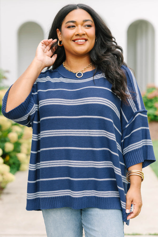 Plus size navy and white striped sweater with a flowy fit, crew neck, and elbow-length sleeves.