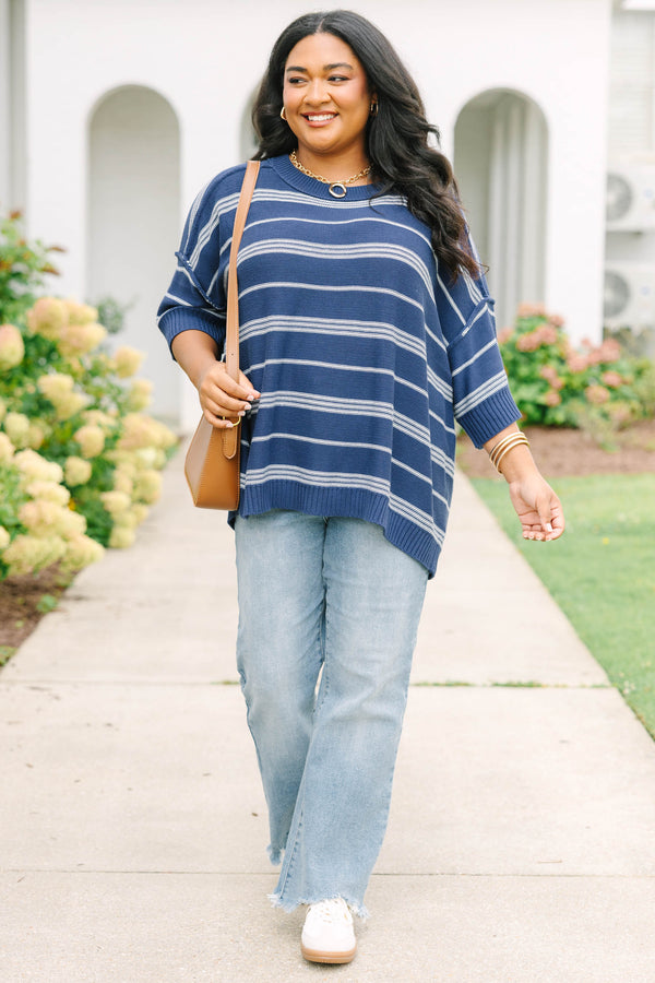 Plus size navy and white striped sweater with a flowy fit, crew neck, and elbow-length sleeves.