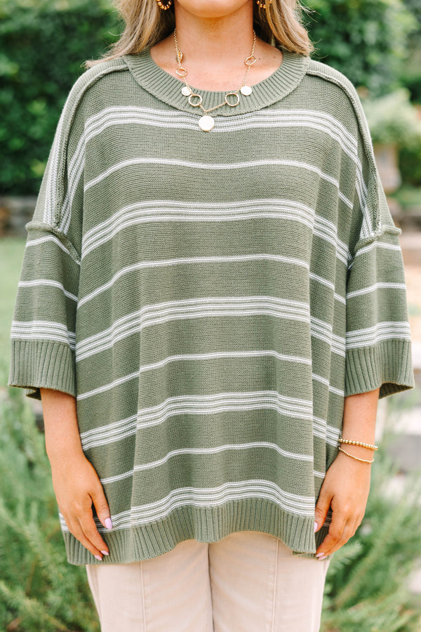 Plus Size olive green oversized knit sweater with white horizontal stripes and a crew neckline.