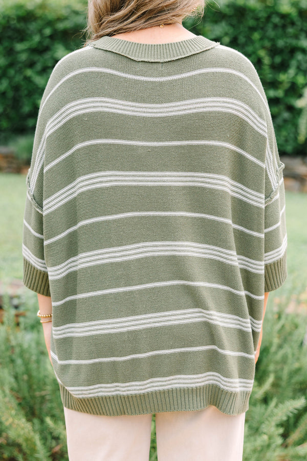 Plus Size olive green oversized knit sweater with white horizontal stripes and a crew neckline.