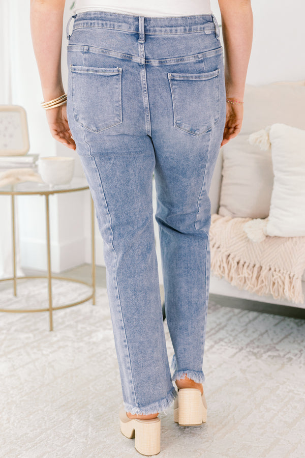 Chic Soul plus size clothing, light wash bootcut jeans with raw hem at the bottom of the legs and a button and zipper fly closure