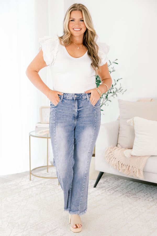 Chic Soul plus size clothing, light wash bootcut jeans with raw hem at the bottom of the legs and a button and zipper fly closure