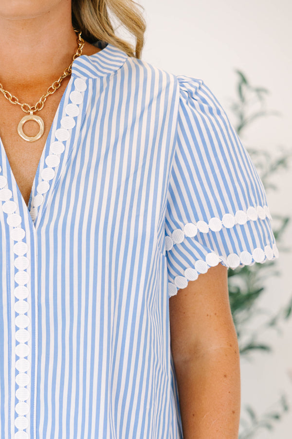 Plus size blue and white striped top with white lace trim, short puff sleeves, and a flowy fit.