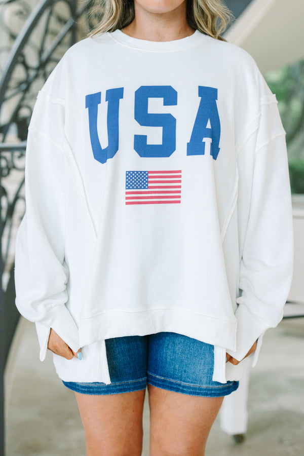 Chic Soul plus size clothing, a loose fitted ivory crew-neck shirt with long drop shoulder sleeves and exposed princess seams. Features a USA graphic with blue text and a small American flag at center front. 