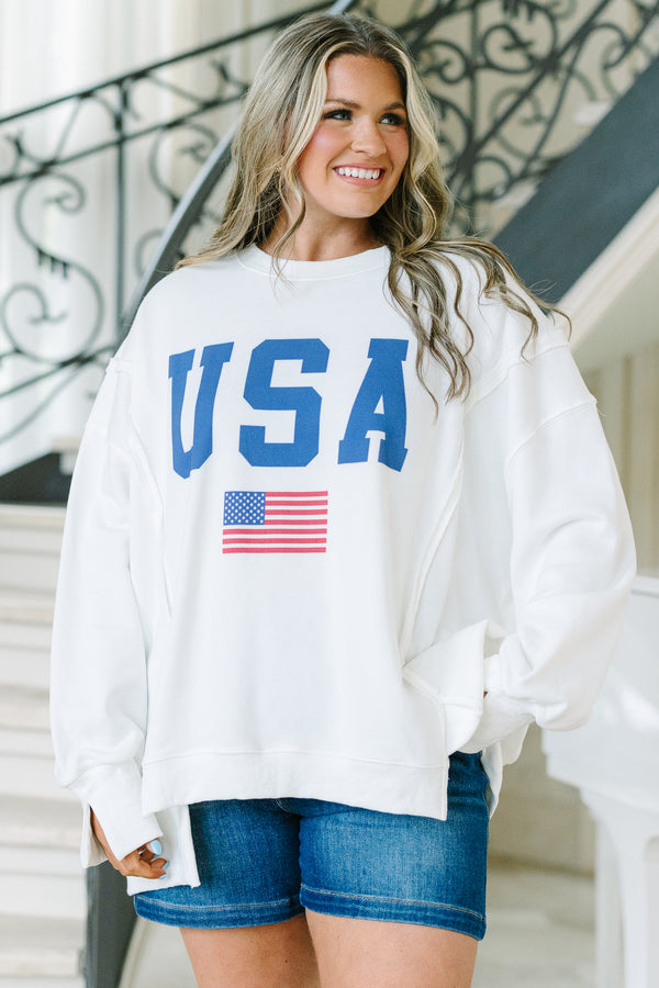 Chic Soul plus size clothing, a loose fitted ivory crew-neck shirt with long drop shoulder sleeves and exposed princess seams. Features a USA graphic with blue text and a small American flag at center front. 
