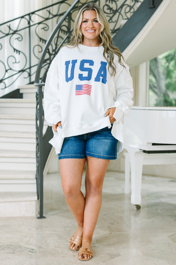 Chic Soul plus size clothing, a loose fitted ivory crew-neck shirt with long drop shoulder sleeves and exposed princess seams. Features a USA graphic with blue text and a small American flag at center front. 