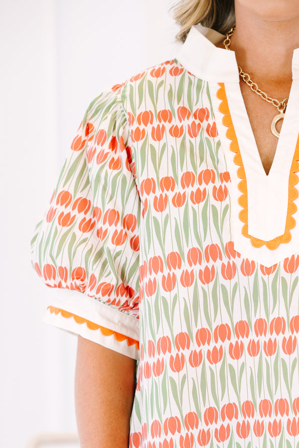 Plus Size orange and green tulip print tunic top with puff sleeves and scalloped trim.