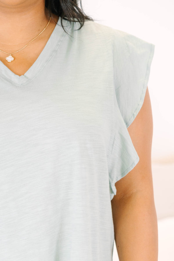 Plus Size light sage v-neck top with ruffled cap sleeves and a relaxed fit.