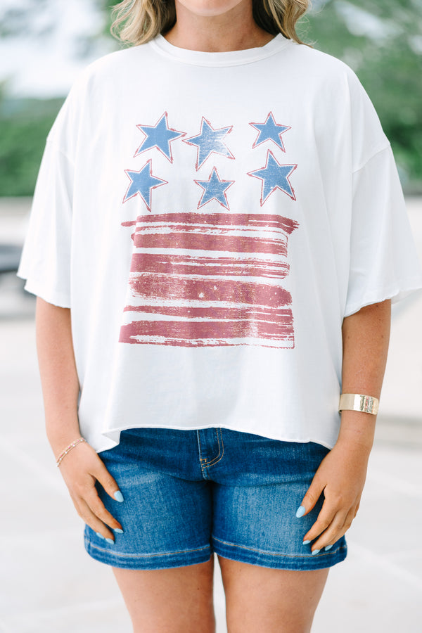 White vintage wash tee with a distressed USA flag graphic, raw-edge sleeves, and an unfinished hem.