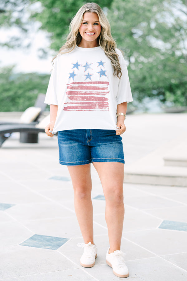 White vintage wash tee with a distressed USA flag graphic, raw-edge sleeves, and an unfinished hem.