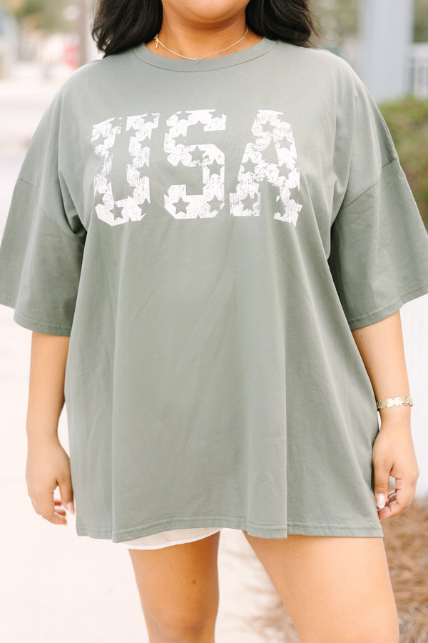 Chic Soul plus size clothing, moss green short sleeve oversized boyfriend tee with “USA” in bold block white font with star cutouts 

