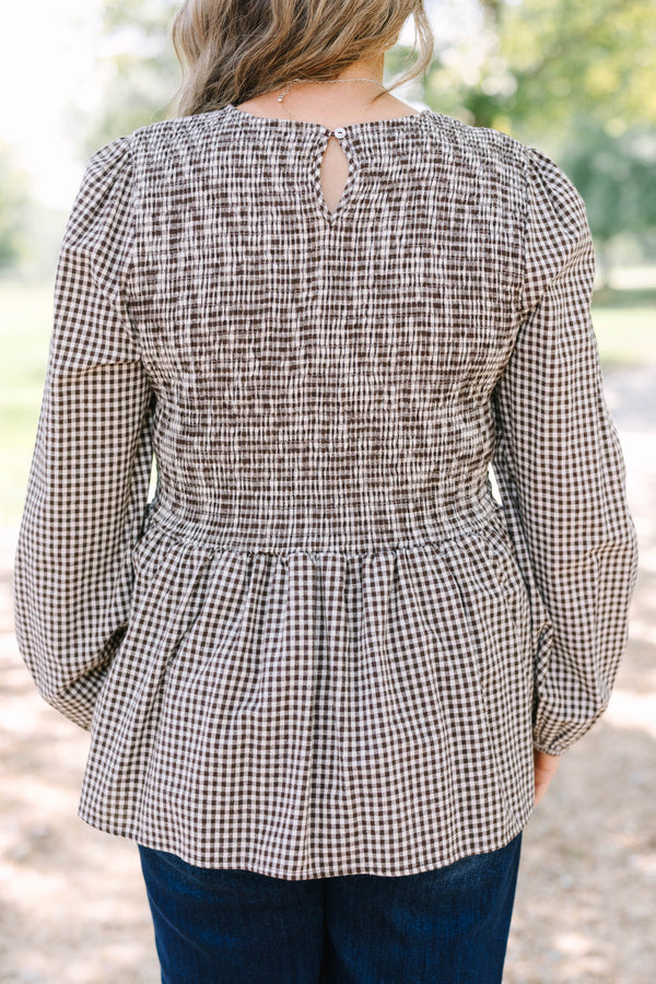 Plus Size brown gingham top with a smocked bodice, long sleeves, and a peplum hem.