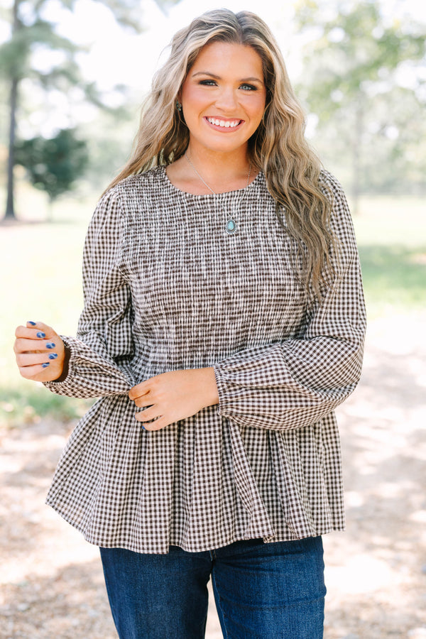 Plus Size brown gingham top with a smocked bodice, long sleeves, and a peplum hem.