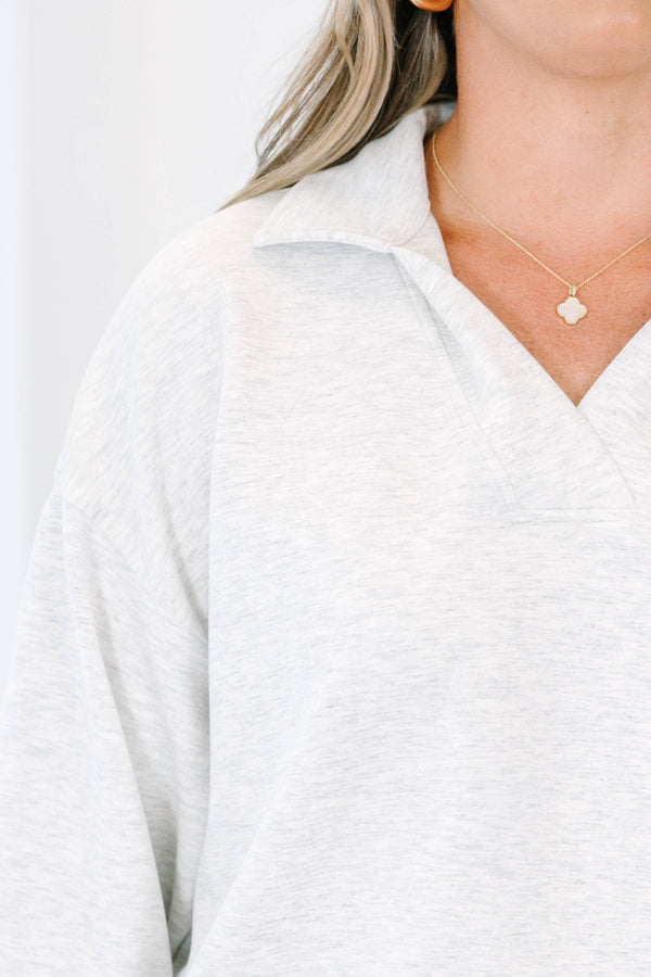 Plus Size light gray heather pullover with a relaxed fit, v-neck collar, and long sleeves.