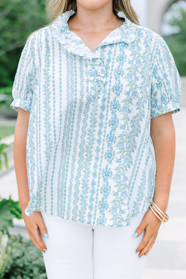 Short-sleeve blue and white floral stripe top with a ruffled button neckline.