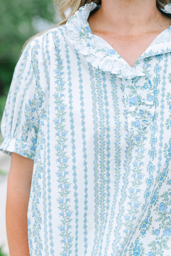 Short-sleeve blue and white floral stripe top with a ruffled button neckline.