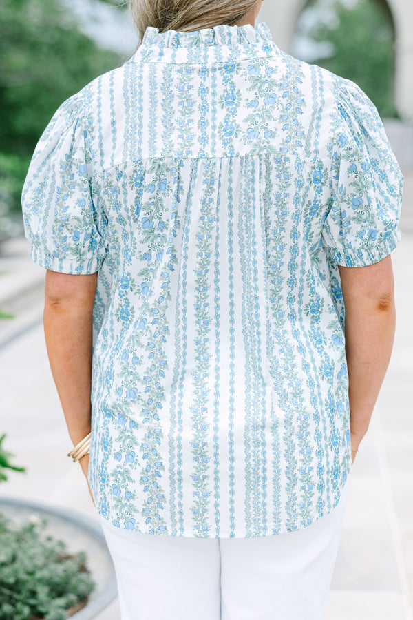 Short-sleeve blue and white floral stripe top with a ruffled button neckline.