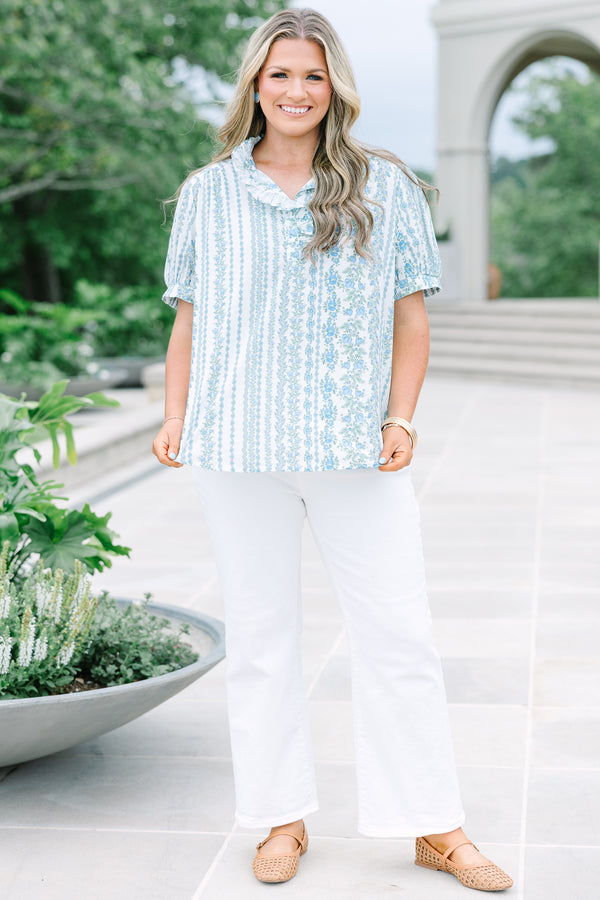 Short-sleeve blue and white floral stripe top with a ruffled button neckline.