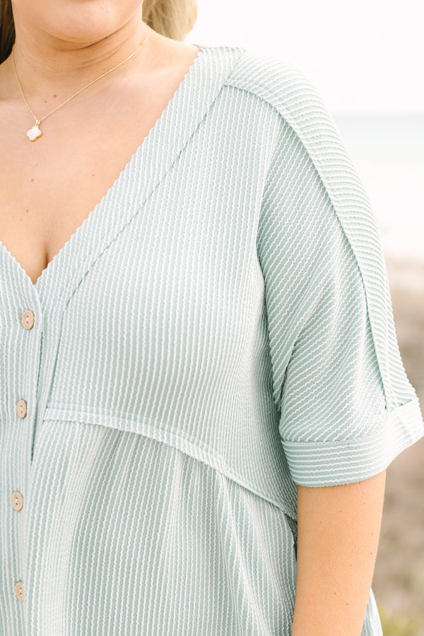 Chic Soul plus size clothing, dusty sage romper with short sleeves that have cuffs at the end of each sleeve as well as buttons going down to the mid stomach area a v-neckline and ribbed texture throughout the romper 
