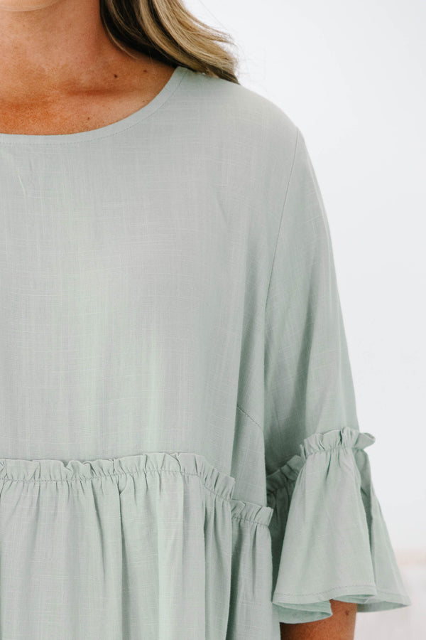 Plus Size sage green babydoll top with elbow-length ruffle sleeves and a round neckline.