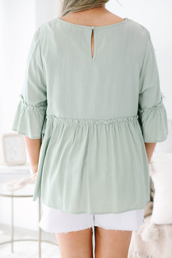 Plus Size sage green babydoll top with elbow-length ruffle sleeves and a round neckline.