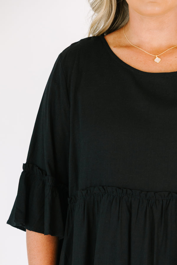 Plus Size black babydoll top with ruffled three-quarter sleeves and a round neckline.