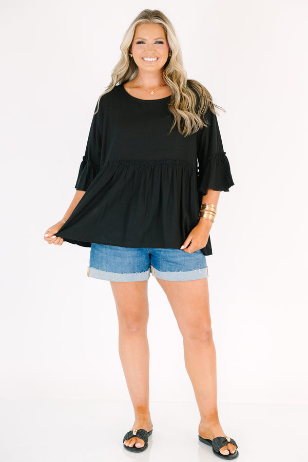 Plus Size black babydoll top with ruffled three-quarter sleeves and a round neckline.