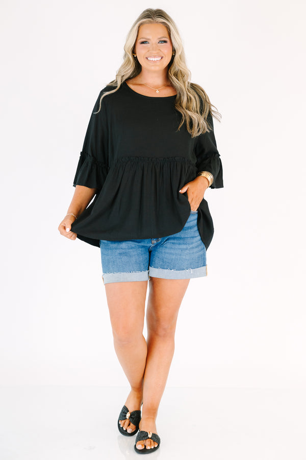 Plus Size black babydoll top with ruffled three-quarter sleeves and a round neckline.