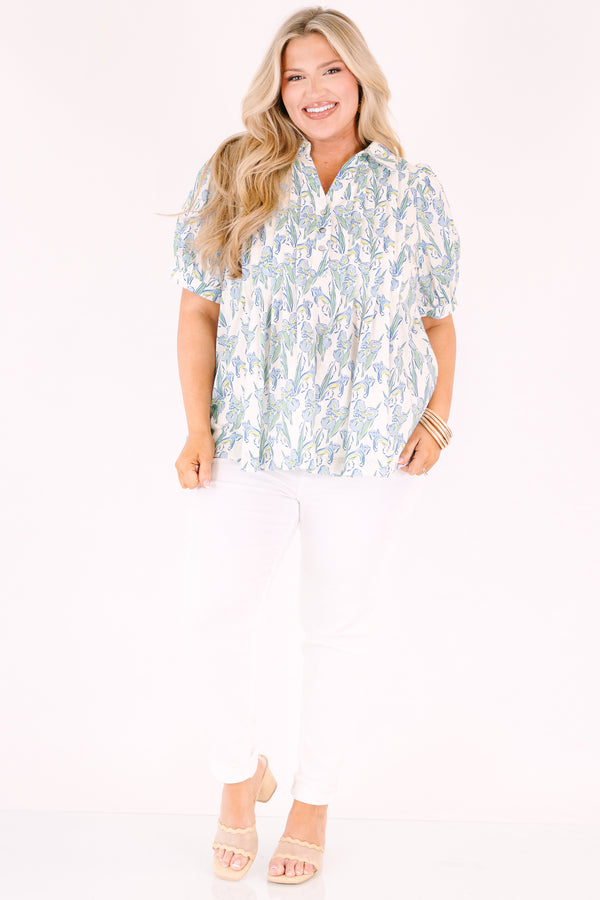 Chic Soul plus size clothing, light blue, green, and yellow floral patterned short puff sleeve top with v neckline and 3 buttons coming down from the neckline
