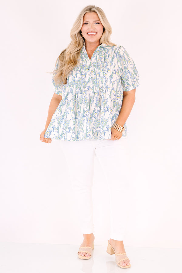 Chic Soul plus size clothing, light blue, green, and yellow floral patterned short puff sleeve top with v neckline and 3 buttons coming down from the neckline
