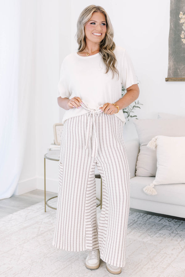 Striped wide leg pants with cream and white stripes with adjustable drawstring and pockets on either side