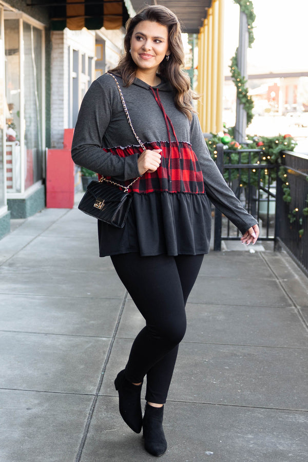Chic Soul plus size clothing long sleeve top with a hoodie. The upper section of the shirt is in a dark gray color, the middle stripe is black and red plaid, and the lower portion is in a black color.
